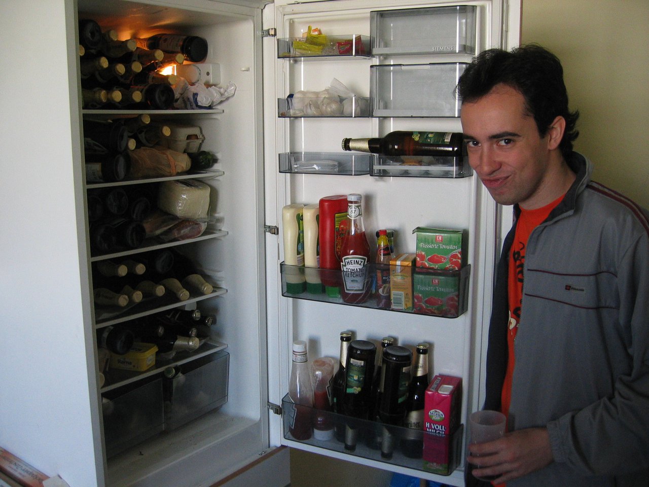 Quique with our beer stash in the fridge of his residence